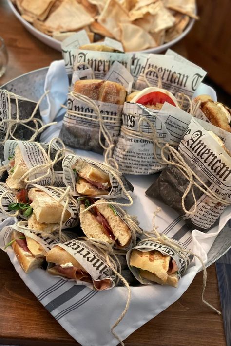 Newspaper wrapped sandwich, italian sandwich, party appetizer, finger foods Newspaper Sandwich Wrap, Sandwich Party Decorations, Finger Foods Packaging, Sandwich Wrapped In Paper, Wrap Packaging Food, Deli Themed Party, Sandwich Shop Aesthetic, Bake Sale Aesthetic, Sandwich Packaging Ideas