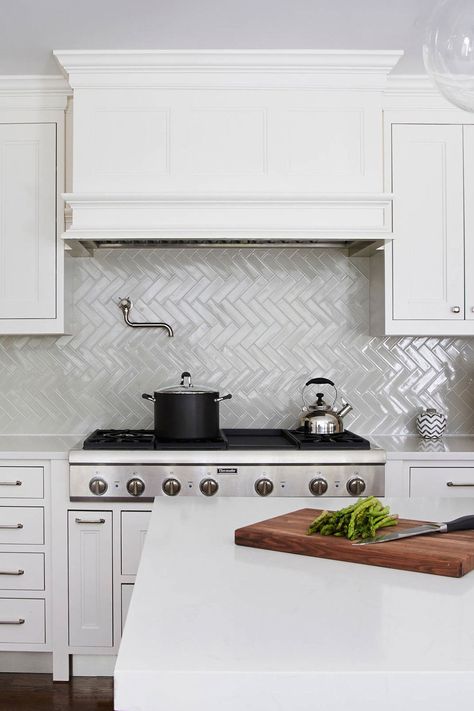 Transitional Kitchen With White Cabinets And Sleek Gray Ceramic Herringbone Backsplash Tiles Herringbone Tiles Kitchen, Herringbone Backsplash Kitchen, White Herringbone Backsplash, Marble Interior Design, Herringbone Tile Backsplash, Update Kitchen, Creative Backsplash Ideas, Brick Backsplash Kitchen, Patterned Tile Backsplash