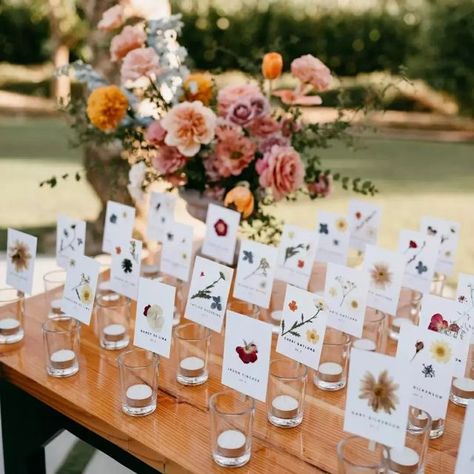 Bonnie Chase on Instagram: "✨ TOP POST OF 2022 ✨ . The sweetest little escort card details for your best buds 🌸 . . . Planning & Design: @eventsbybliss Venue: @erikaonthefarm @florafarms Florals: @floweriize Circle Arch: @emporioartefloral Photography: @thetimeswehave Champagne Tower: @lazygourmetcabo Rentals: @bajaboutiquerentalcompany HMU: @loscabosmakeup Transportation: @impalacabo Signage @uscreating Cake: @knockoutdessert Sparklers: @magichands_sparklersandmore Dj: @alexdjcaboevents Bride Flower Place Cards, Floral Place Cards, Flower Stationary, Flower Place, Wildflower Decor, Wildflower Wedding Theme, Wedding Reception Guest, Circle Arch, Champagne Tower