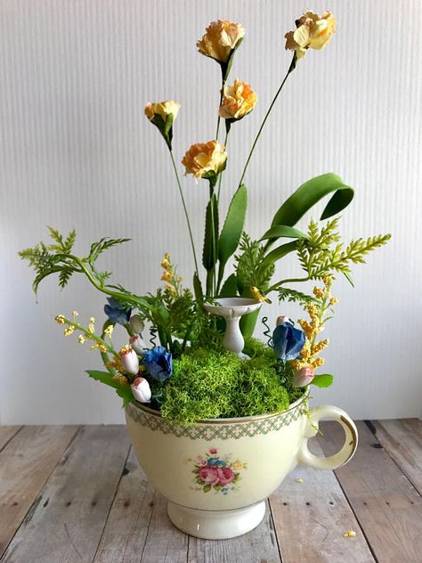 I just finished some gorgeous new tea cup fairy gardens! This vintage tea cup is filled with pretty paper flowers that have been hand tinted, moss, ferns, greenery, handmade clay tulips, and a tiny birdbath. The tea cup features a floral bouquet design and a trellis pattern with Teacup Fairy Garden, Tiny Fairy Garden, Hedgehog Crafts, Fae Garden, Garden Homes, Tiny Gardens, Diy Succulent Terrarium, Fairies Garden, Teacup Gardens