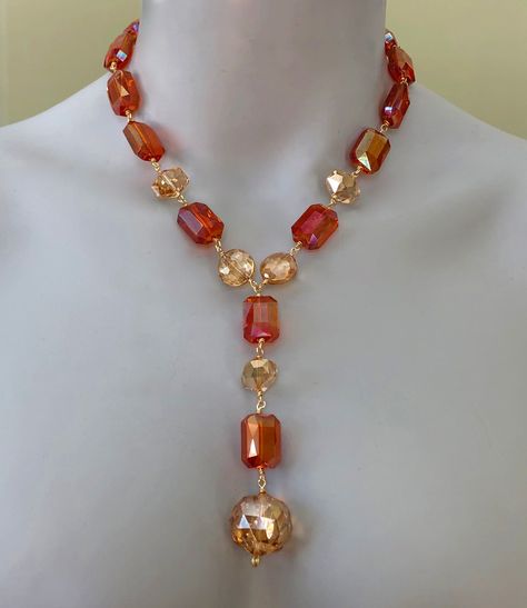 "This crystal statement necklace is full of sunny colour and sparkle.  It will be a spectacular addition to your summer/resort wardrobe but can be worn year-round as well. To create it, I used mystic sunset orange crystal rectangles and mystic citrine crystal coins, geometrics, rondelles and ball.   Using gold non-tarnish wire, I wire-wrapped the crystals to one another in a Y shape so that the drop traces the décolletage.   Length:  18.5\" + 4\" drop." Chunky Necklaces Statement, Diy Necklace Making, Keshi Pearl Necklace, Turquoise Statement Necklace, Gray Necklace, Crystal Statement Necklace, Sunset Orange, Orange Crystals, Citrine Necklace