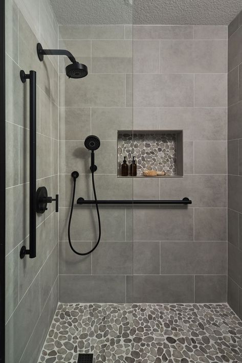 Bathroom Remodeling Ideas -  A transitional shower design with river rock floor and niche accent. Large format grey tile on the walls. Matte black fixtures. Restroom Remodel, Tub To Shower Remodel, Full Bathroom Remodel, Master Shower, Bathroom Redesign, Bathroom Remodel Designs, Bathroom Remodel Shower, Shower Remodel, Bathroom Remodel Master