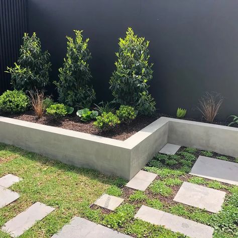 18 Cheap Retaining Wall Ideas Using Affordable Materials Stucco Planters Retaining Walls, Short Garden Wall, Diy Retaining Wall Ideas, Concrete Retaining Wall Landscape, Retaining Wall Options, Diy Retaining Wall Cheap, Short Retaining Wall Ideas, Cement Retaining Wall, Low Retaining Wall Ideas