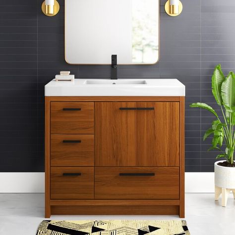 Modern sophistication is defined within the finish and bar pulls of this vanity. Its length makes it the perfect addition to any sized home and saves space with its storage area hidden behind the double cabinet doors and one bottom drawer. Topped with a highly durable resin white countertop and an integrated sink, this modern design will add everlasting class to your bathroom and powder room. Removable Backsplash, 36 Inch Vanity, Engineered Stone Countertops, Walnut Cabinets, White Quartz Countertop, White Sink, White Countertops, Wood Vanity, Engineered Stone