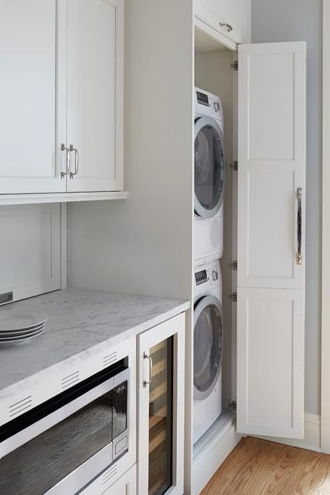 Galley style kitchen featuring hidden stacked washer and dryer in a white cabinet finished with a chrome pull. Hidden Laundry Rooms, Laundry In Kitchen, Grey Laundry Rooms, Hallway Laundry, Stacked Laundry Room, Hidden Laundry, Chicago Vintage, Pantry Laundry, Galley Style Kitchen