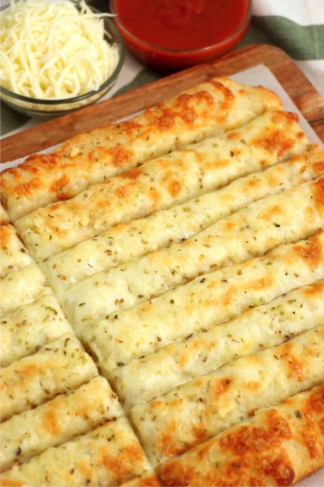 Homemade Cheese Sticks - Delicious garlic pizza crust breadsticks brushed in buttery garlic and layered with cheese. Melty, bubbly, cheesy perfection! Quick Cheesy Breadsticks, Pizza Crust Garlic Cheese Bread, Garlic Cheese Sticks With Pizza Crust, Pizza Bread Sticks Recipe, Pizza Crust Cheese Bread, Cheesy Pizza Sticks, Cheesy Garlic Bread Pizza, Garlic Cheese Pizza Bread, Homemade Garlic Cheese Breadsticks