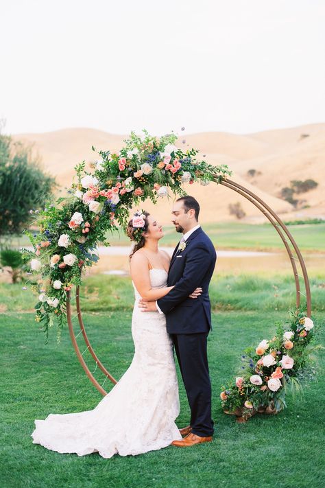 Kristina and Michael added beautiful flowers to a circle arch for their Vineyard Lawn ceremony at Wente Vineyards. Circle arches create a stunning backdrop for any outdoor ceremony. Grace Kathryn Photography. Wooden Wedding Arches, Circle Arch, Wedding Ceremony Ideas, Rustic Boho Wedding, Wedding Ceremony Arch, Wedding Arch Flowers, Wedding Arbour, Arch Flowers, Arch Decoration Wedding