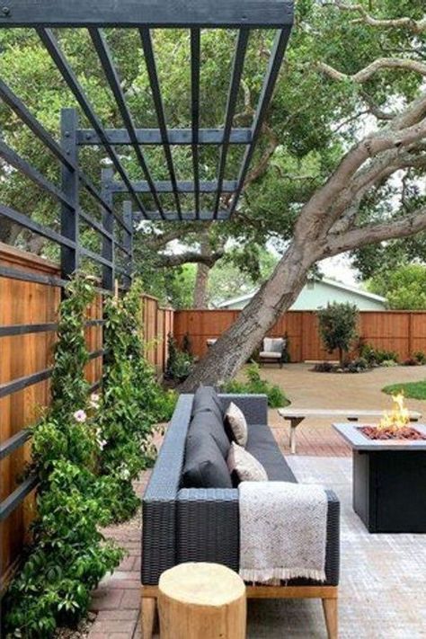 From the perfect space heaters to warm things up to the best decor to create that cozy vibe, here are 15 winter patio ideas that will make your outdoor area a delightful place that you actually want to spend time in, even when it's cold outside. #hunkerhome #winterpatioideas #patioideas #patio #patiodecorideas Privacy Fence With Pergola Top, Exterior Home Walkways, Trellis Pergola Ideas, Corner Of Yard Ideas Backyards, Trellis Patio Cover, Oklahoma Backyard Landscaping, Modern Yard Design, Gorgeous Backyards, Cantilevered Pergola