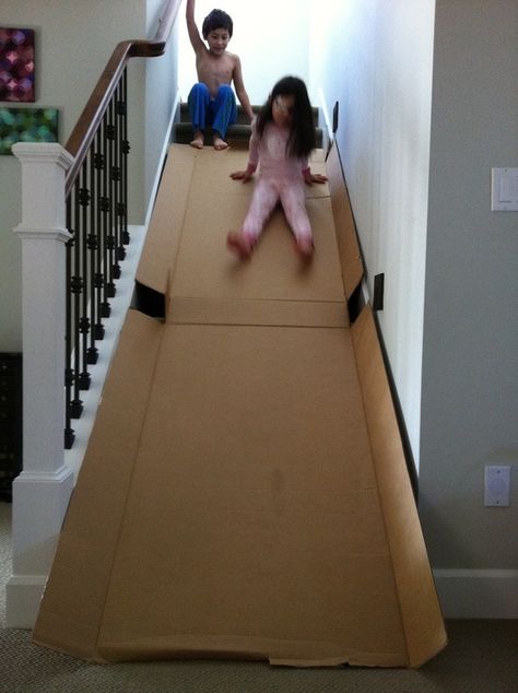 Fun thing to do with a refrigerator box and stairs!!! Love to do this myself Cardboard Box Fort, Cardboard Boxes Kids, Stair Slide, Diy Slides, Cardboard Box Crafts, Cardboard Toys, Diy Kids Toys, Indoor Fun, Kids Discover