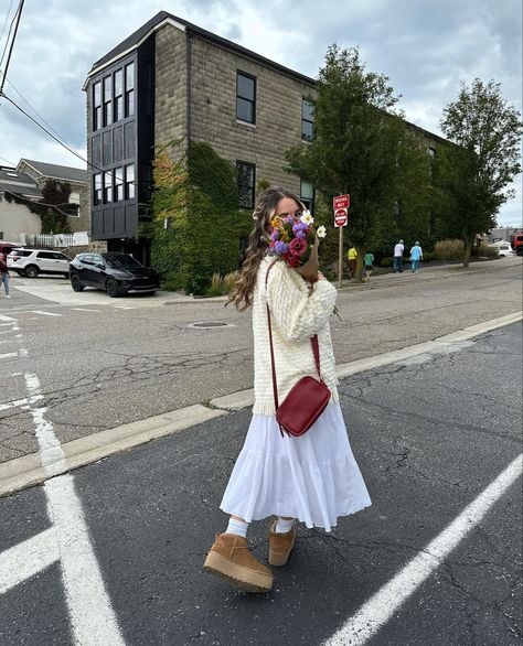 fall maxi skirt outfit rory gilmore sweater platform mini uggs inspo flower boquet brown paper inspo autumn vibes Ugg Boot Skirt Outfit, Ugg Spring Outfit, Skirts And Uggs Outfits, Long Dress And Uggs Outfit, Lace Uggs Outfit, Uggs With Skirt Fit, Maxi Skirt And Sweater Outfit Fall, Ugg Tasman Skirt Outfit, Ugg And Skirt Outfit