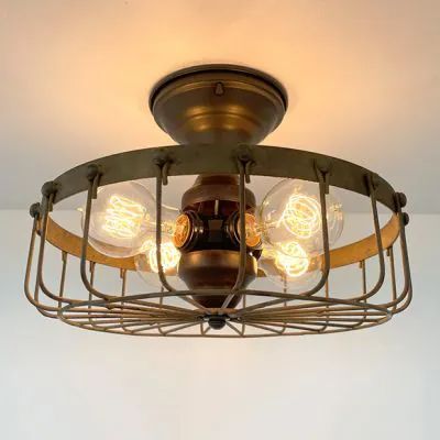 A FIRESIDE GLOW | Shop Sales Events Antique Farmhouse Cage Light Fixture, Edison Bulb Lamp, Cage Ceiling Light, Cage Light, Industrial Ceiling Lights, Industrial Ceiling, Cabin Lighting, Farmhouse Industrial, Farmhouse Chandelier