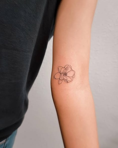 Fine line magnolia flower tattoo located on the inner Magnolia Tattoo Inner Arm, Dainty Magnolia Flower Tattoo, Arm Poppy Tattoo, Magnolia Line Drawing Tattoo, Small Gardenia Flower Tattoo, Small Flower Tattoo Inner Arm, One Line Magnolia Tattoo, Mini Magnolia Tattoo, Flower Tattoos Location