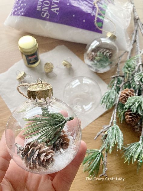 DIY pine snow globe ornaments Projects With Clear Ornaments, Diy Craft Christmas Ornaments, Glass Ball Ornament Ideas Easy Diy, Clear Tree Ornament Ideas, Diy Ornaments Unique, Glass Christmas Balls Ideas, Fake Snow Ornaments Diy, Christmas Glass Ornaments Diy Ideas, Filled Glass Ornaments