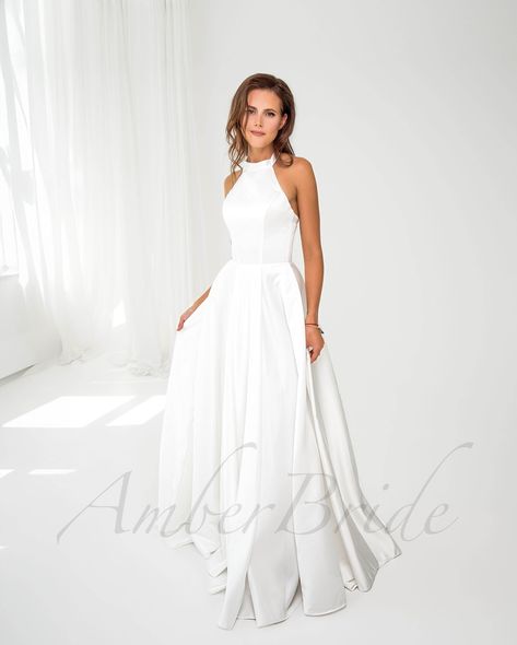 Discover the perfect blend of style and functionality with our modest halter neck satin wedding dress, designed with pockets and a graceful long train. 👰🌟 . . . #HalterNeckDress #SatinWeddingDress #ModestBride #LongTrainDress #WeddingDressInspo #BridalFashion #WeddingGown #ElegantBride #BridalGown #WeddingInspiration #DreamDress #BridalCollection #WeddingStyle #TimelessBeauty #BridalWear #WeddingDayLook #StylishBride #PocketsInDresses #BridalElegance #WeddingMagic #BridalChic #ModernBride #... High Neck Satin Wedding Dress, Simple Ivory Wedding Dress, Simple Wedding Dress Satin, High Neckline Wedding Dress, Halterneck Wedding Dress, Wedding Dress High Neck, Wedding Dress Halter, Halter Neck Wedding Dress, Wedding Dress Halter Neck