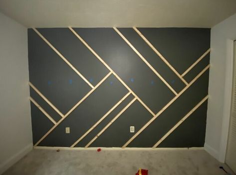 Give your wall some dramatic character with this easy to-do accent wall! Paint the wall I started by painting the wall and the baseboard with the color intended for the whole wall. Mark the studs Using a stud finder, we marked where all the studs in the wall were using blue painter's tape. Cut your wood We used 1"x2" furring strips. We measured the length of the wall where we wanted to place the first piece of wood. I recommend doing your longest lines first. Cut both ends… Dramatic Character, Tape Wall, Stud Finder, Accent Wall Designs, Accent Wall Paint, Accent Wall Ideas, Bedroom Wall Designs, Bedroom Wall Paint, Accent Walls In Living Room