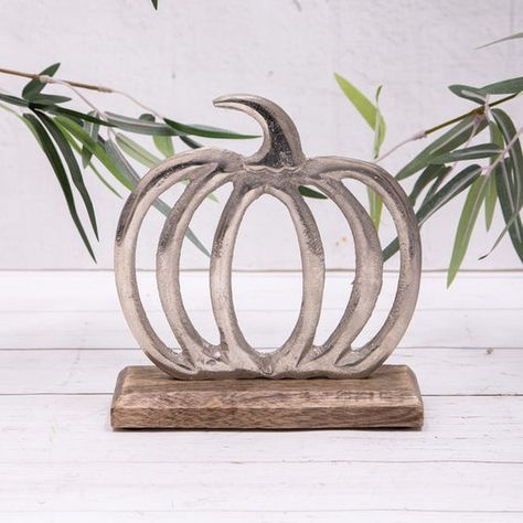 "Minimal yet striking—this metal pumpkin sculpture brings rustic charm with a modern touch! 🍁✨ Whether on a mantel or as a centerpiece, it’s the perfect fall decor addition. Handcrafted with attention to detail, it’s both timeless and chic. 🎃🖤 #FallDecor #RusticElegance #MinimalistDesign #PumpkinVibes #AutumnAesthetic #HandcraftedBeauty #UniqueDecor #MetalArt #ModernFallDecor #HarvestSeason #TimelessStyle #ArtisticPumpkin" Hallowwen Decor, Pumpkin Sculpture, Halloween Cut Outs, Cactus Candles, Silver Pumpkins, Modern Fall Decor, Pumpkin Ornament, Metal Pumpkins, Outdoor Mirror