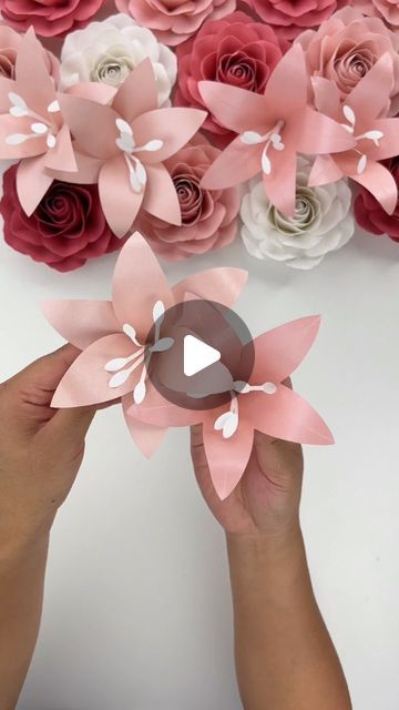 Hey, I’m Judy 👋🏻 Paper Flower Art + Tutorials on Instagram: "Here is the tutorial for my Mini Lily Template - there are two “designs” included mainly because I couldn’t pick one I liked most (and I figured anyone who wanted the template would like the two options).   The template uses very little paper per flower and I think these would be great to fill in gaps in paper flower bouquets or displays!   For paper, I used the two pink shimmer cardstock pack from @michaelsstores and I also used @bearlyarts glue for design 2. Using craft glue allows for more flexibility in the petal for shaping.   The Mini Lily Template is available in my Etsy shop, link in bio! I will also put a link in my stories and it will be saved to my “tutorial” highlights.  #paperflowers #lilies #cricut #cricutmade #te How To Make Lily Flower With Paper, Paper Lily Flower, Lily Template, Tiny Paper Flowers, Cardstock Paper Crafts, Lilium Flower, Paper Flower Bouquets, Paper Lily, Paper Flower Templates