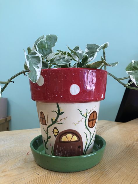 Gnome home style plant pot #potterypainting #ceramcs #paintyourownpottery #flowerpot #paintingideas Cute Clay Pot Painting Ideas, Succulent Pot Ideas Paint, Cute Pot Plant Painting Ideas, Fairy House Pottery Painting, Mushroom Flower Pot Painting, Animal Painted Pots, Drawing On Plant Pot, Pottery Planter Painting Ideas, Cottage Core Plant Pots