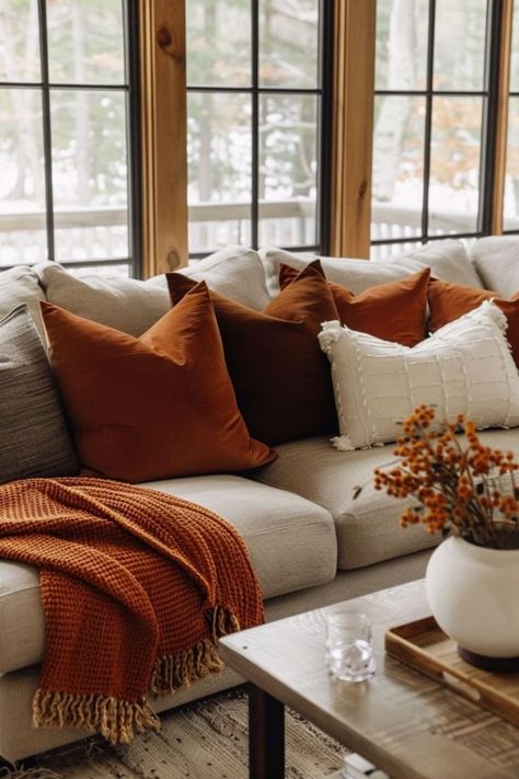 Orange Rustic Living Room, Fall Vibes Aesthetic Living Room, Burnt Orange Living Room Accents, Tan And Rust Living Room, Rustic Orange Home Decor, Burnt Orange Lounge Decor, Burnt Orange Apartment Decor, Fall Color Home Decor, Living Room With Burnt Orange Accents