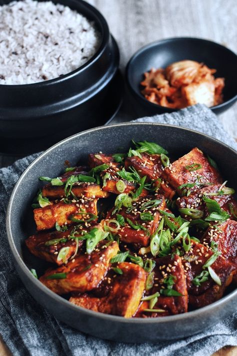 Korean Spicy Braised Tofu, also known as Dubu Jorim, is easy, quick, and absolutely delicious. Thick slices of tofu are braised in a mouthwatering sauce that's equal parts savory, spicy, and full of umami flavor. A 15-minute recipe that's full of good-for-you, plant-based protein that's simmered in sauce until tender. Satisfying, simple, and tasty -- it's a Korean home cooking staple for a reason! Dubu Jorim Recipe, Korean Banchan Recipes, Korean Sides, Dubu Jorim, Korean Feast, Korean Soy Sauce, Korean Banchan, Braised Tofu, Tofu Sauce