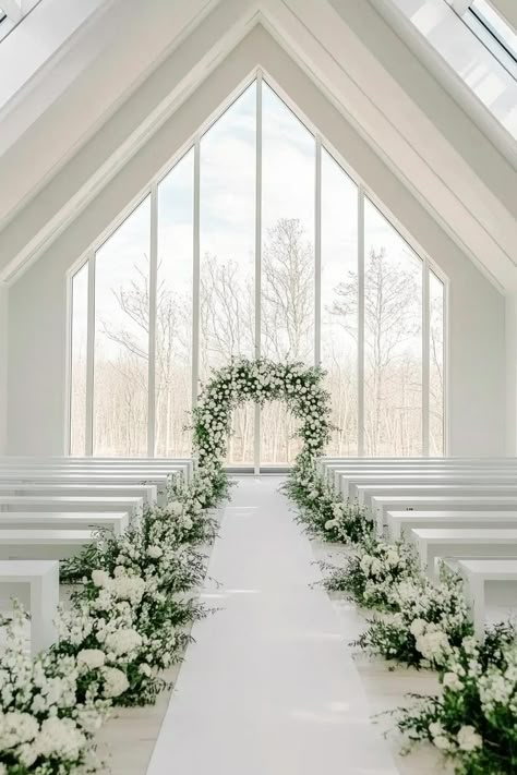 Bright and elegant wedding aisle with floral arrangements. Get enchanted by wedding decor ideas that remain elegant across the ages while impressing even the pickiest Aunt Mildred. White Rose Wedding Aisle Decor, Outside Wedding Aisle Runner, White Wedding Aisle Runner, Isle Rugs Wedding, White Floral Aisle Arrangements, Floral Wedding Aisle Decorations, Wedding Floral Aisle Arrangements, Church Styling Wedding, Wedding Aisle White Flowers