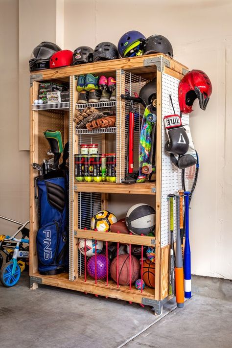 Tired of organizing and taking out sports equipment for weekly practice. Storing sports equipment can feel a bit overwhelming, but luckily we have the perfect solution to keep all your equipment in one place. Our DIY Sports Equipment Organizer provides ample storage with separate compartments and shelves to keep everything neatly organized. Build it today following our guided step-by-step free downloadable plan on our blog Connecticut House, Sports Equipment Organization, Garage Hacks, Sports Equipment Storage, Garage Storage Inspiration, Gear Room, Sports Storage, Garage Organisation, Shed Organization