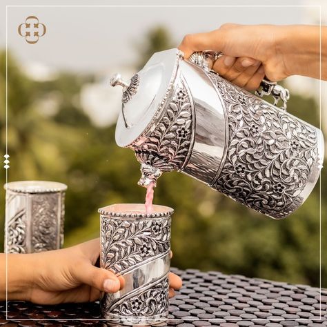 A great addition to a cozy family picnic or a festive holiday party with friends, this Silver Water Jug Set is a versatile household highlight for your home. This opulent design features a sleek curved handle and intricate, hand-embossed floral detailing. Video call Facility available for NRI Clients along -Safe and Secure Shipping -92.5 Pure Silver -Wide range of collection in Each Category +91 9094949409 Silver Water Jugs, Silver Home Accessories, Silver Jug, Pooja Items, Silver Pooja Items, Party With Friends, Silver Water, Family Picnic, Dinner Set