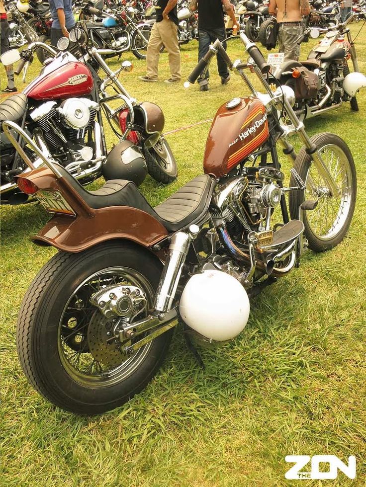 several motorcycles are parked on the grass at a motorcycle show