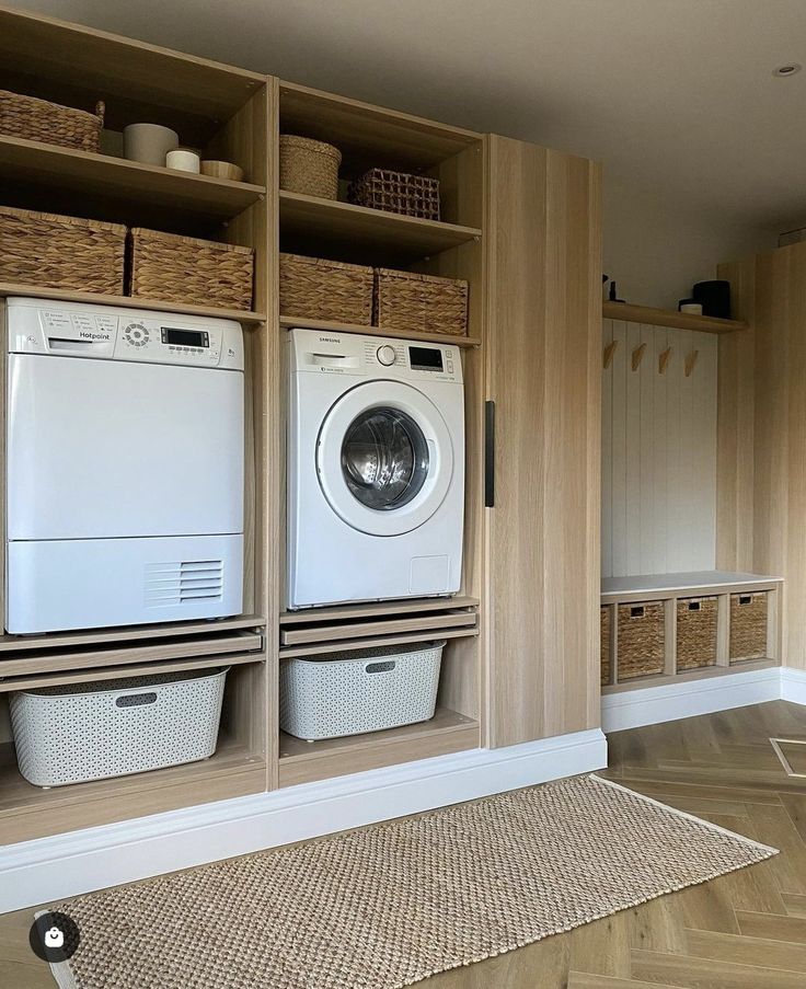 a washer and dryer in a room with wooden shelves