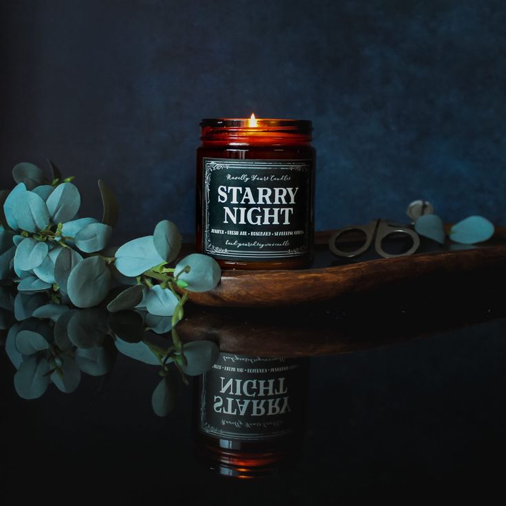 a candle sitting on top of a table next to flowers