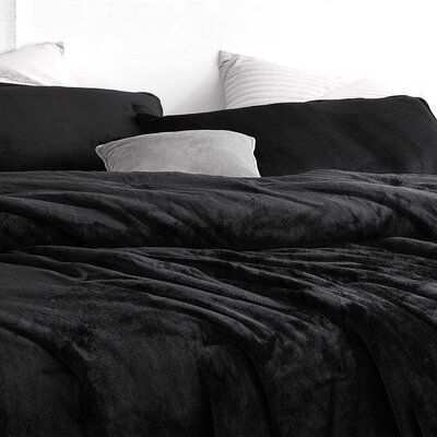 a black and white photo of a bed with two pillows