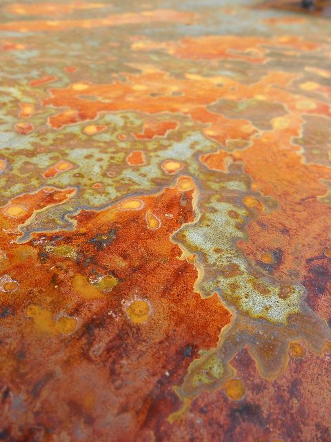 rusted metal surface with orange and yellow colors