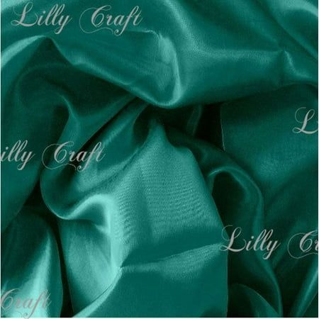 a green satin fabric with the word lilly craft on it