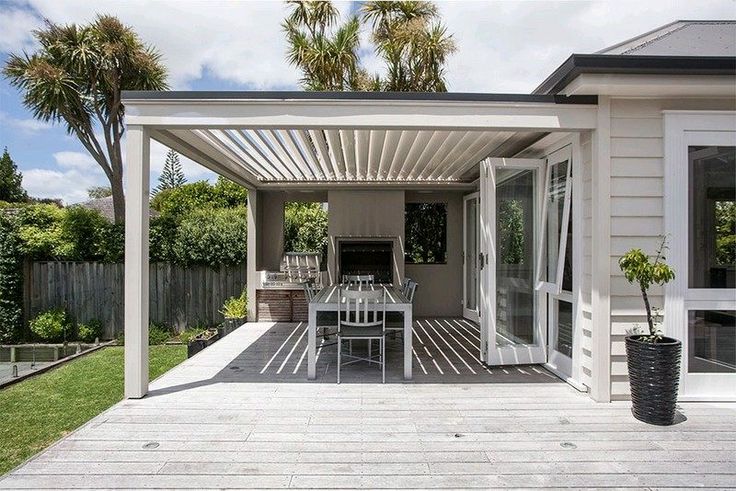 a patio with a table and chairs on it