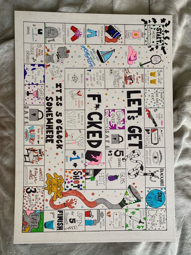 a game board with words and pictures on it sitting on a sheet covered in silver foil