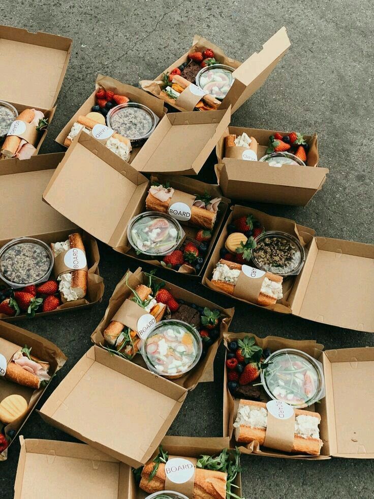 several open boxes filled with different types of food and condiments on the ground