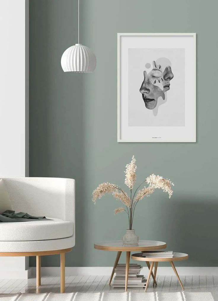 a living room with green walls and white furniture