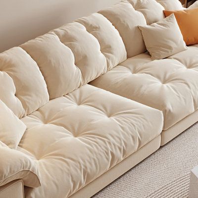 a white couch with several pillows on it