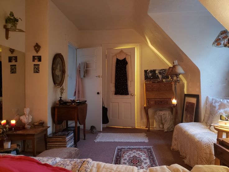 a bedroom with two beds and a dresser in the corner, next to a doorway