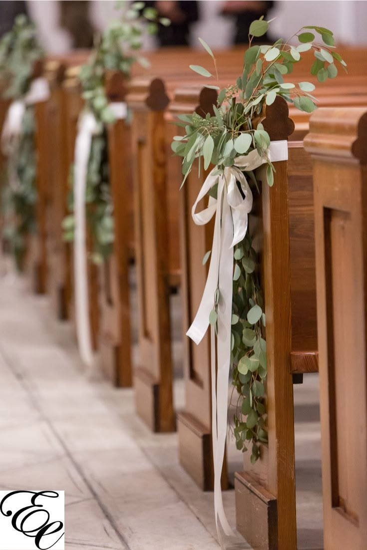 rows of wooden pews decorated with greenery and ribbons