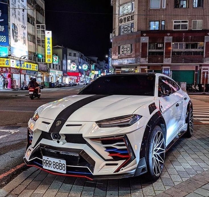 a white sports car parked on the side of a street