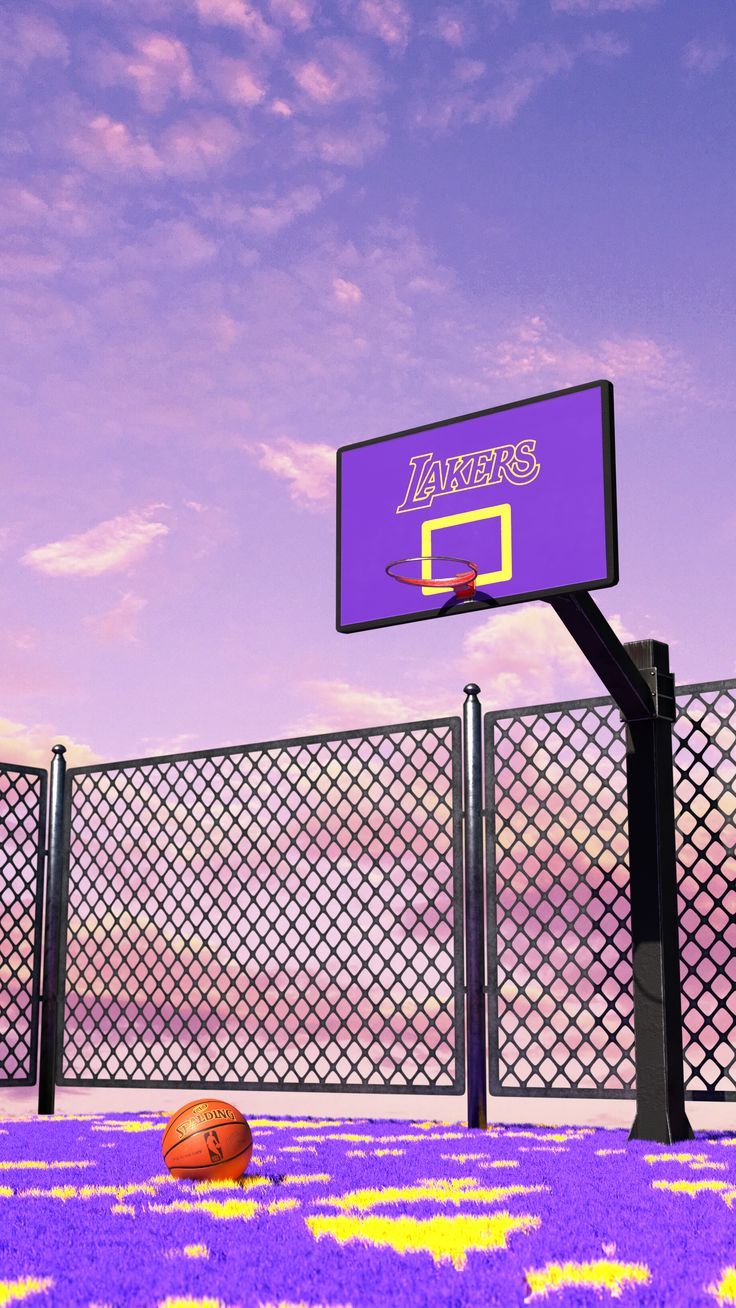 a basketball is on the ground in front of a purple and yellow court with a sign that says lakers