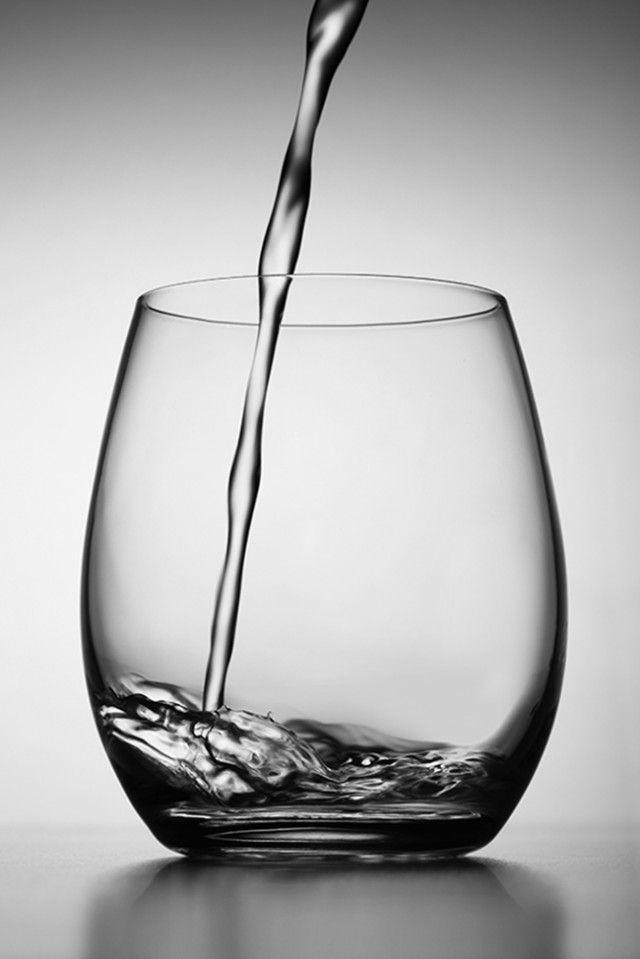 a glass filled with water on top of a table