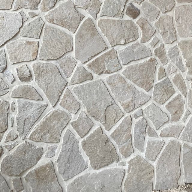 a stone wall that looks like it has been made out of rocks and is grey