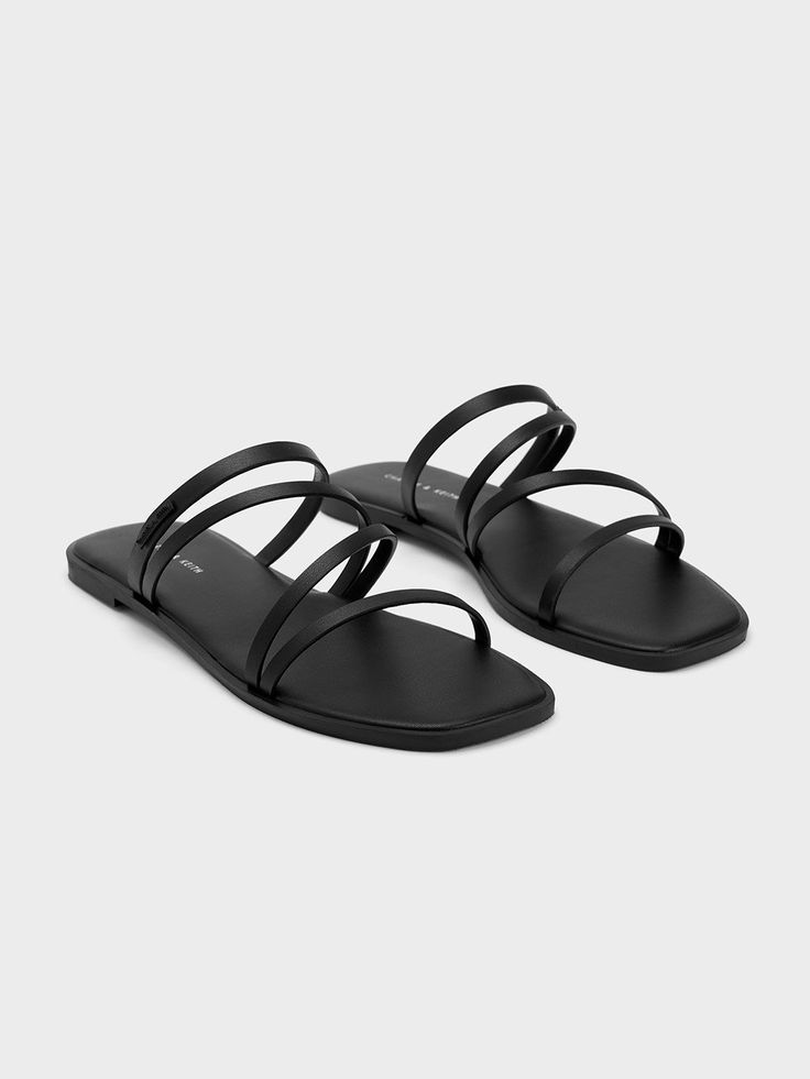 Bridesmaid Shoes Flat Black, Sleek Black Flat Sandals, Casual Black Toe Ring Sandals For Vacation, Sleek Black Open Toe Slingback Sandals, Sleek Black Sandals For Spring, Sleek Open Toe Sandals For Summer, Sleek Open Toe Slides For Summer, Sleek Open Toe Sandals For The Beach, Modern Black Sandals For Vacation