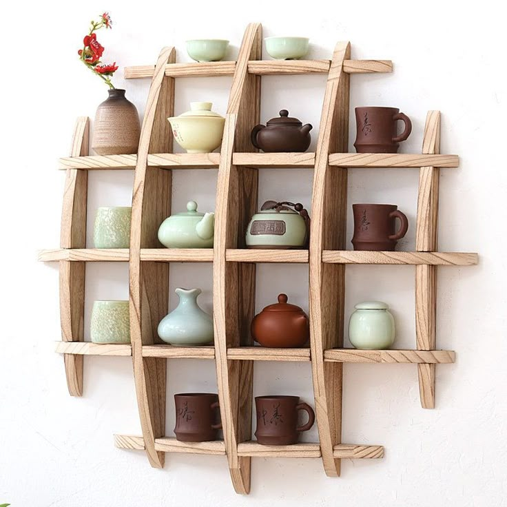 a wooden shelf with cups and vases on it