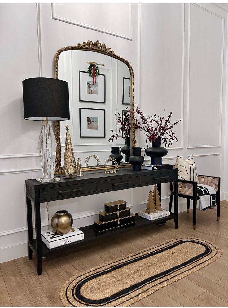 a living room with a black table and mirror