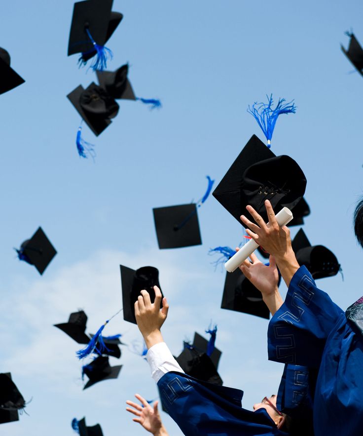 graduates tossing their caps in the air