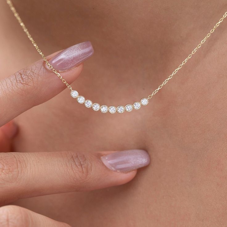 Elevate your style with our dainty 14k Curved Bar Diamond Necklace. This minimalist and handcrafted piece features a delicate bar pendant adorned with sparkling diamonds, making it the perfect wedding gift for her. Embrace the elegance and timeless beauty of this handmade diamond jewelry. Order now and make a statement of sophistication! Alternatively, choose from our options of natural, lab-grown diamonds or dazzling moissanites at three different price points to fit your unique preferences and budget. Please check below to see specifications of each stone option. All our pieces come with Azalea Certification and Warranty document.  Independent appraisals cost an additional $60. All pieces over $2,000 come with free appraisal. M A T E R I A L & L E N G T H Available in 14k Yellow Gold, 14 Diamond Necklace Pendant Ideas, Diamond Necklace Designs Unique, Minimalist Diamond Necklace, Diamond Birthday, Dainty Bar Necklace, Necklace Bar, Diamond Bar Necklace, Diamond Necklace Designs, Curved Bar