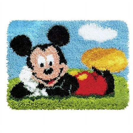 a mickey mouse rug with a yellow frisbee in it's mouth and a blue sky background